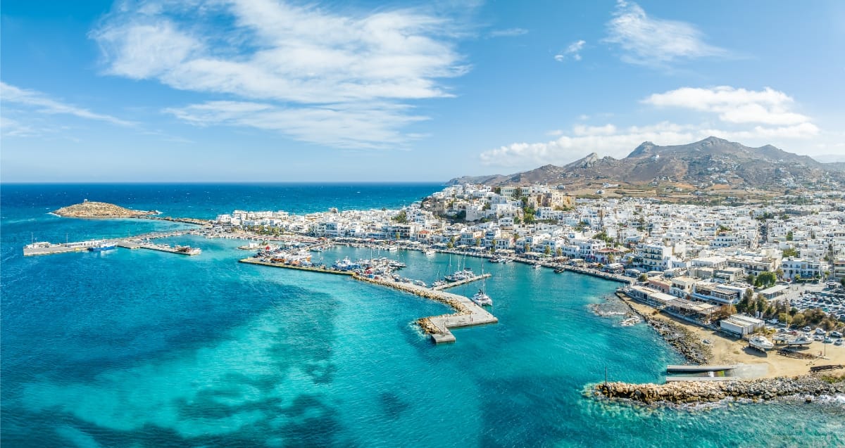 Scenic panorama of Naxos Chora, highlighting the town's white buildings and blue sea, set in the beautiful Cyclades islands